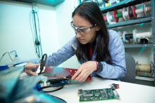 Mechanical design engineer Kelsey Sawvelle works on an ASML XLR-960ix DUV (deep ultraviolet] laser system in a DUV laser lab at ASML’s San Diego R&D center.